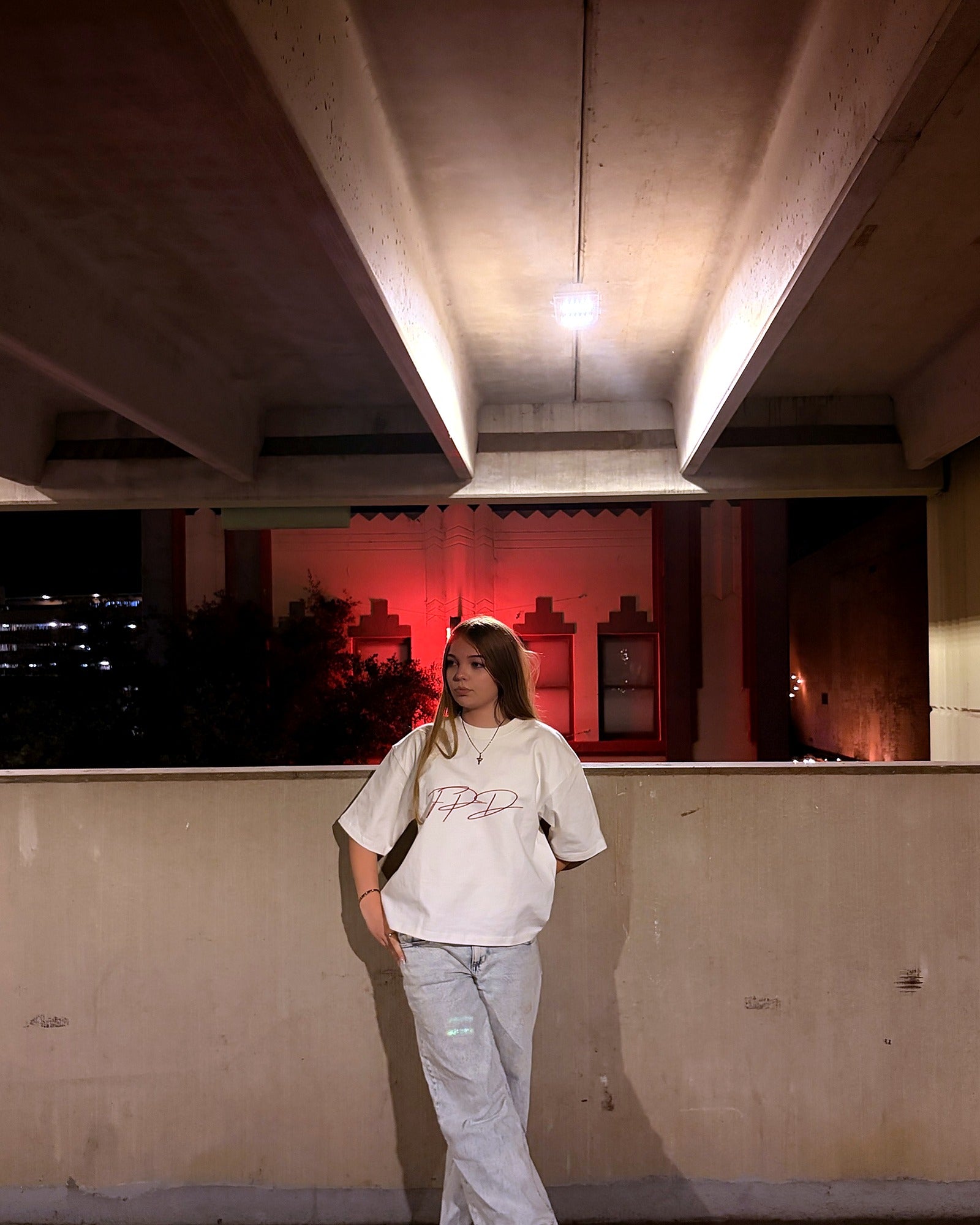 Model wearing Fuego Para Dios white shirt at night