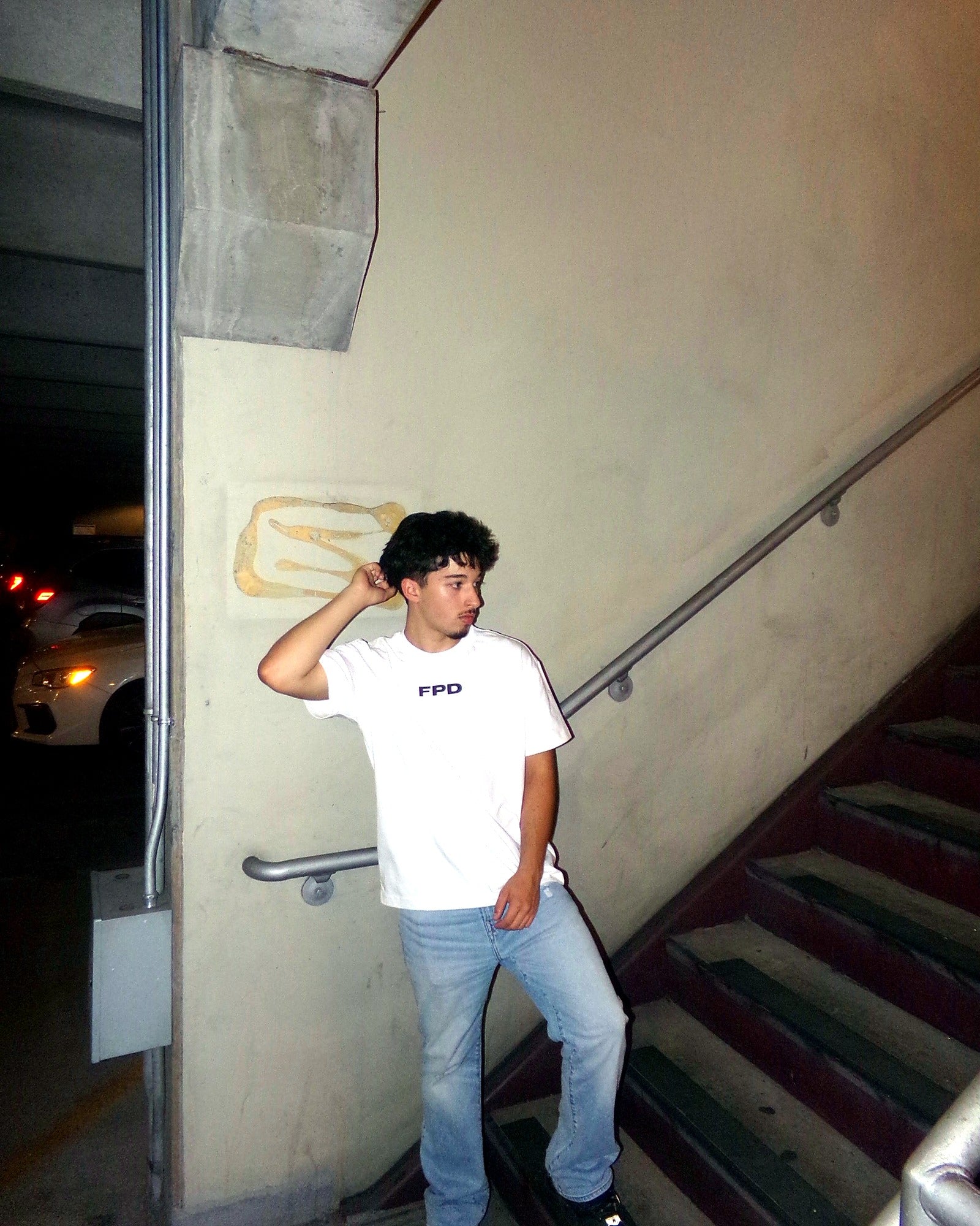 Model in white FPD shirt on staircase